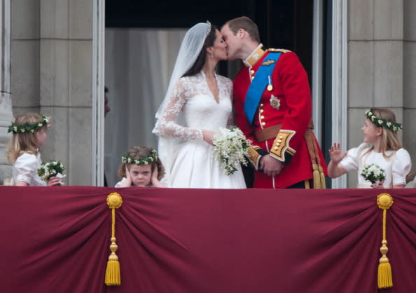 Catherine, Duchess of Cambridge, and Prince William, Duke of Cambridge, kiss on the balcony of Buckingham Palace following their wedding at Westminster Abbey on April 29, 2011 in London, England.