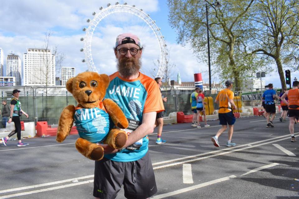 Watford Observer: Actor Jamie de Courcey and his father's Nookie Bear at mile 25 of the London Marathon