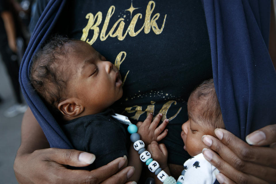 Eight-week-old twins Zuri and Zakai Simmorins are held by their mother Samara Simmorins during a protest Sunday, June 7, 2020, near the White House in Washington, over the death of George Floyd, a black man who was in police custody in Minneapolis. Floyd died after being restrained by Minneapolis police officers. With four sons she has fears for their safety as they grow up. (AP Photo/Jacquelyn Martin)