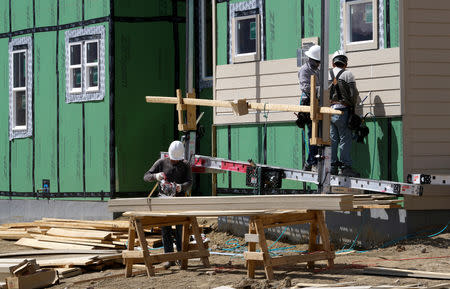 FILE PHOTO: Workers construct a new home in Leyden Rock in Arvada, Colorado, U.S. August 30, 2016. REUTERS/Rick Wilking/File Photo