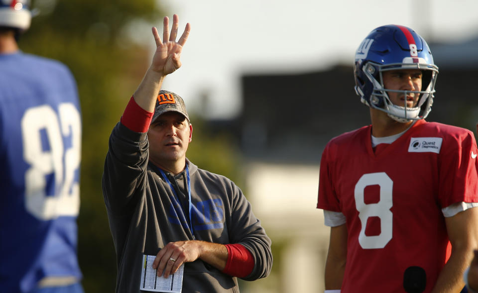 New York Giants head coach Joe Judge, left, signals a play during an NFL football training camp Saturday, July 31, 2021, in Newark, N.J. (AP Photo/John Munson)