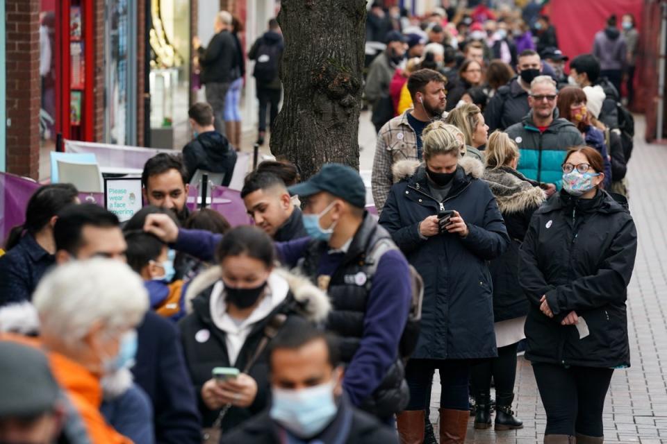 Hundreds of people queue at a vaccination centre on Solihull High Street, West Midlands (PA)