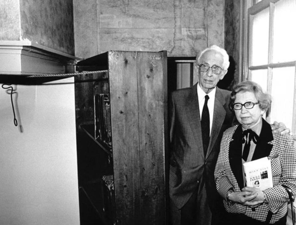 Miep and Jan Gies, years later, stand by the bookcase that hid a secret entrance to the hiding place of Anne Frank, her family and four others in Nazi-occupied Amsterdam (EPA)