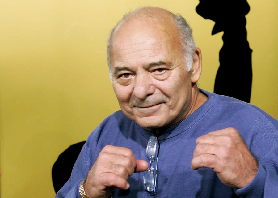 Burt Young, a cast member of the film “Rocky Balboa,” gestures at the premiere of the film in Los Angeles, Dec. 13, 2006. Burt Young, the Oscar-nominated actor who played Paulie, the rough-hewn, mumbling-and-grumbling best friend, corner-man and brother-in-law to Sylvester Stallone in the “Rocky” franchise, has died. Young died Oct. 8, 2023 in Los Angeles. (AP Photo/Kevork Djansezian, File)