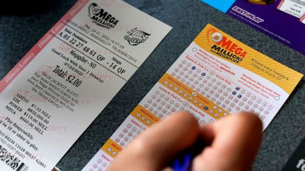 PHOTO: A customer fills out a Mega Millions lottery ticket at a convenience store, July 21, 2022, in Northbrook, Ill. (Nam Y. Huh/AP)