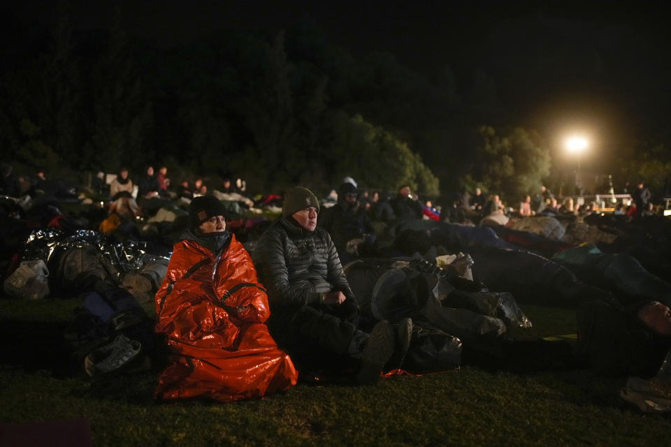 People gather prior the Dawn Service ceremony at the Anzac Cove beach, the site of the April 25, 1915, World War I landing of the ANZACs (Australian and New Zealand Army Corps) on the Gallipoli peninsula, Turkey, early Tuesday, April 25, 2023. During the 108th Anniversary of Anzac Day, travelers from Australia and New Zealand joined Turkish and other nations' dignitaries at the former World War I battlefields for a dawn service Tuesday to remember troops that fought during the Gallipoli campaign between British-led forces against the Ottoman Empire army. (AP Photo/Emrah Gurel)