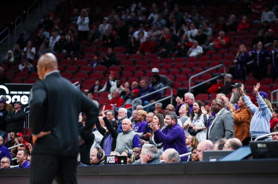 Kentucky Wesleyan fans cheer in the background as Kenny Payne looks onto the court during Louisville’s exhibition loss earlier this year.