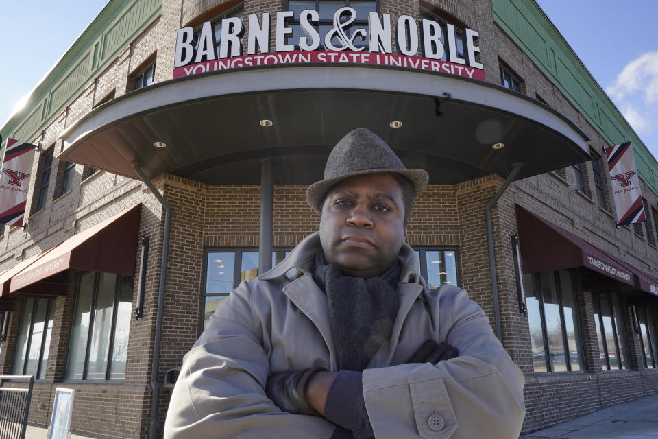 Andre Brady poses for a photo outside the Barnes & Noble, Thursday, Jan. 21, 2021, in Youngstown, Ohio. On its surface, the story of Brady's fight to keep his well-paying union job at a public university bookstore that was privatized isn't unique. Hundreds of workers have watched as their positions at once-independent college bookstores disappeared in recent years as operations were transferred to national book retailing giants. What makes the Ohio man's case notable is that it created a five-year paper trail that provides rare detail on the handover of the store from Youngstown State University to Barnes & Noble. (AP Photo/Tony Dejak)