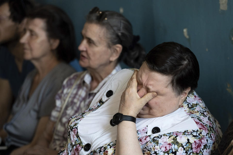 A woman reacts emotionally during a meeting of former employees of a manufacturing plant where visually impaired people used to work until it was shuttered following a Russian air assault, in Kyiv, Ukraine, on May 30, 2023. Losing the place of work is just one of a multitude of challenges that people with visual impairments face across Ukraine since Russia launched a full-scale invasion in February 2022. (AP Photo/Roman Hrytsyna)