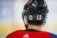 Apr 7, 2018; Calgary, Alberta, CAN; Calgary Flames left wing Johnny Gaudreau (13) wears a sticker for the Humboldt Broncos junior hockey team on his helmet during the warmup period before a game against the Vegas Golden Knights at Scotiabank Saddledome. Mandatory Credit: Sergei Belski-USA TODAY Sports