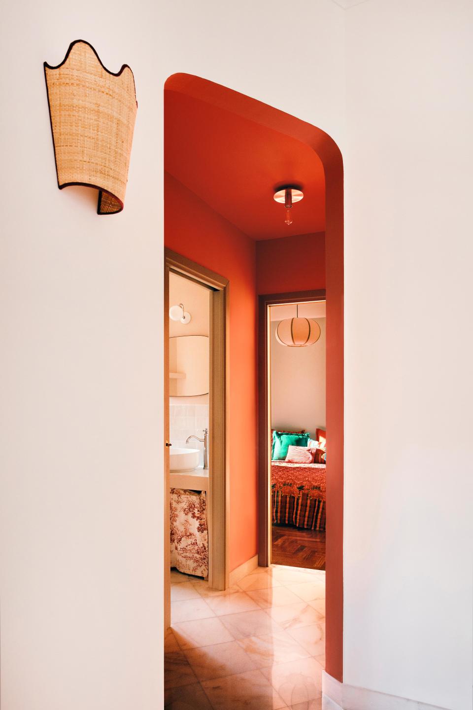 Curves and color add warmth and visual interest throughout the small apartment.