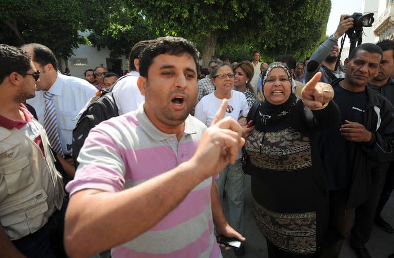 Tunisian citizens insult the lawyers representing the three European FEMEN activists outside the court in Tunis on June 5, 2013