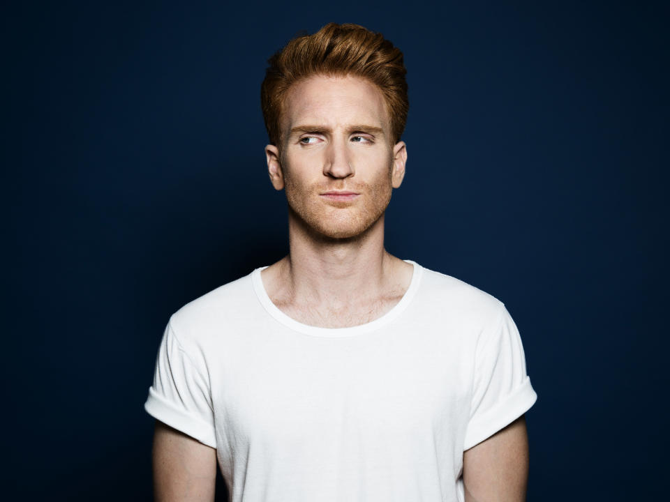 Man looking to the side in a white T-shirt