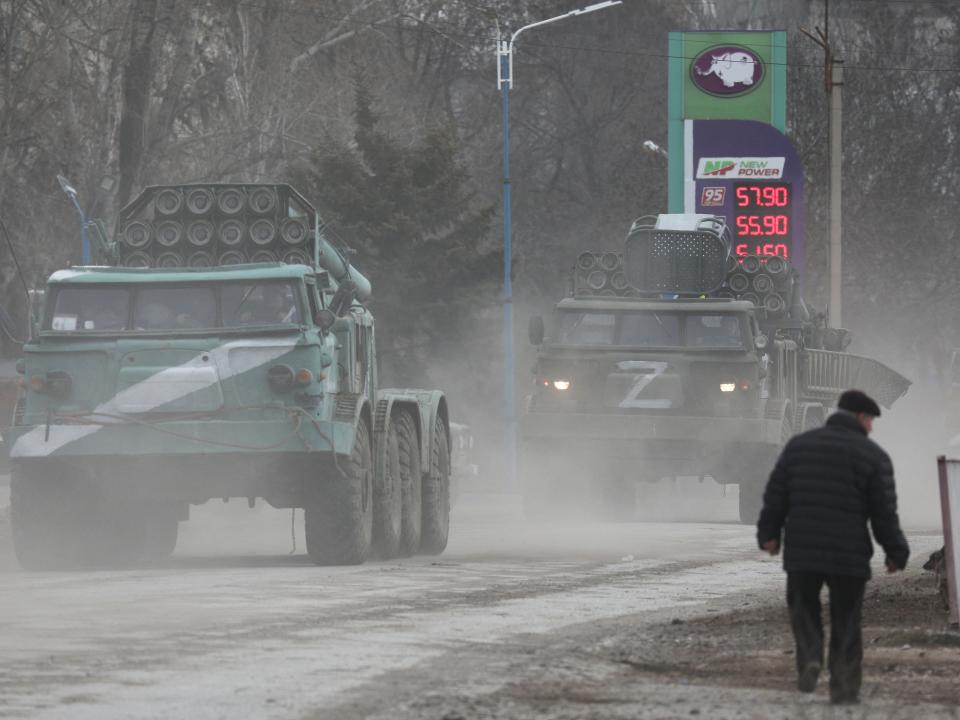 Russian military vehicles drive along a street in the town of Armyansk in Crimea (REUTERS)