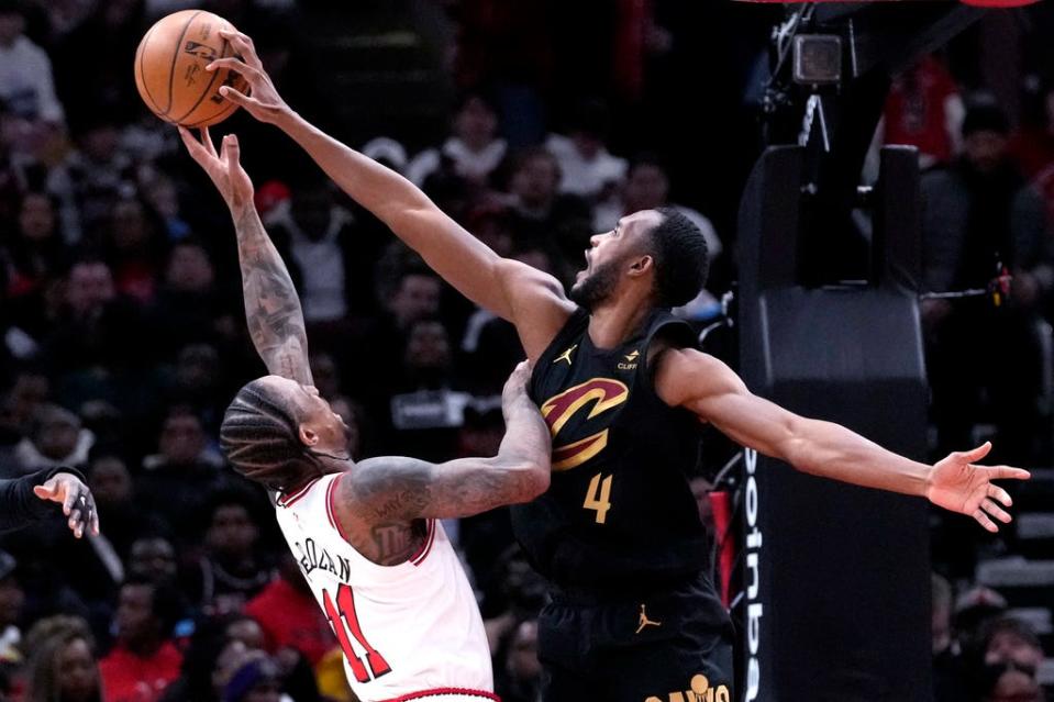 Cleveland Cavaliers forward Evan Mobley, right, blocks a shot by Chicago Bulls forward DeMar DeRozan during the first half of an NBA basketball game in Chicago, Wednesday, Feb. 28, 2024. (AP Photo/Nam Y. Huh)