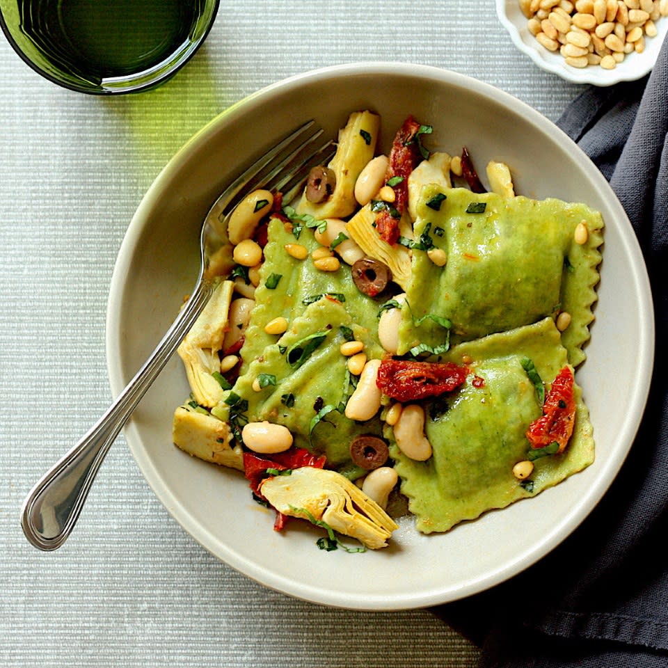 <p>Store-bought spinach ravioli and a handful of basic pantry items are all you need to get a healthy dinner on the table in 15 minutes. Ingredients like oil-packed sun-dried tomatoes, briny Kalamata olives and toasty pine nuts help to build big flavor fast. If you can't find frozen artichokes, swap in a 15-ounce can (just be sure to drain and rinse them well). <a href="https://www.eatingwell.com/recipe/274008/spinach-ravioli-with-artichokes-and-olives/" rel="nofollow noopener" target="_blank" data-ylk="slk:View Recipe;elm:context_link;itc:0;sec:content-canvas" class="link ">View Recipe</a></p>