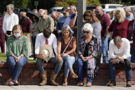 People pray during a vigil at the Collierville Town Hall, Friday, Sept. 24, 2021, in Collierville, Tenn. The vigil is for the person killed and those injured when a gunman attacked people in a Kroger grocery store Thursday before he was found dead of an apparent self-inflicted gunshot wound. (AP Photo/Mark Humphrey)