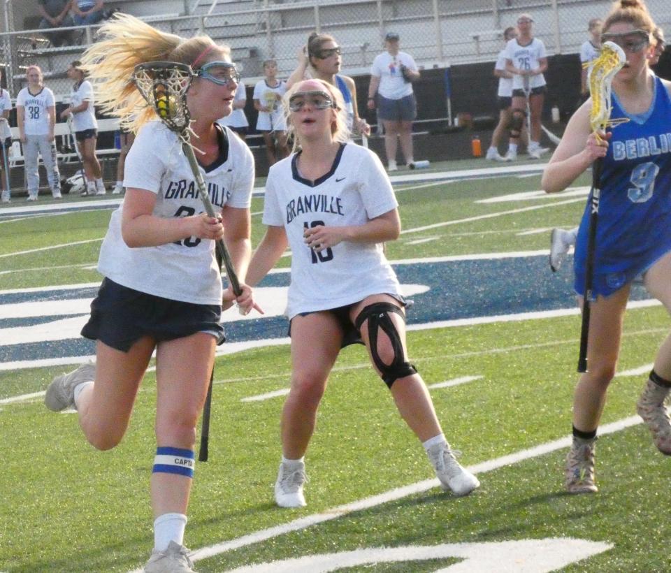 Granville senior Clare Hotchkiss works the ball upfield during a Division II first-round match against Olentangy Berlin at Walter J. Hodges Stadium on Thursday, May 19, 2022. The Blue Aces beat the visiting Bears 11-8.