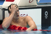 Nic Fink of the United States rests after his swim in the men's 200-meter breaststroke final at the 2020 Summer Olympics, Thursday, July 29, 2021, in Tokyo, Japan. (AP Photo/Matthias Schrader)