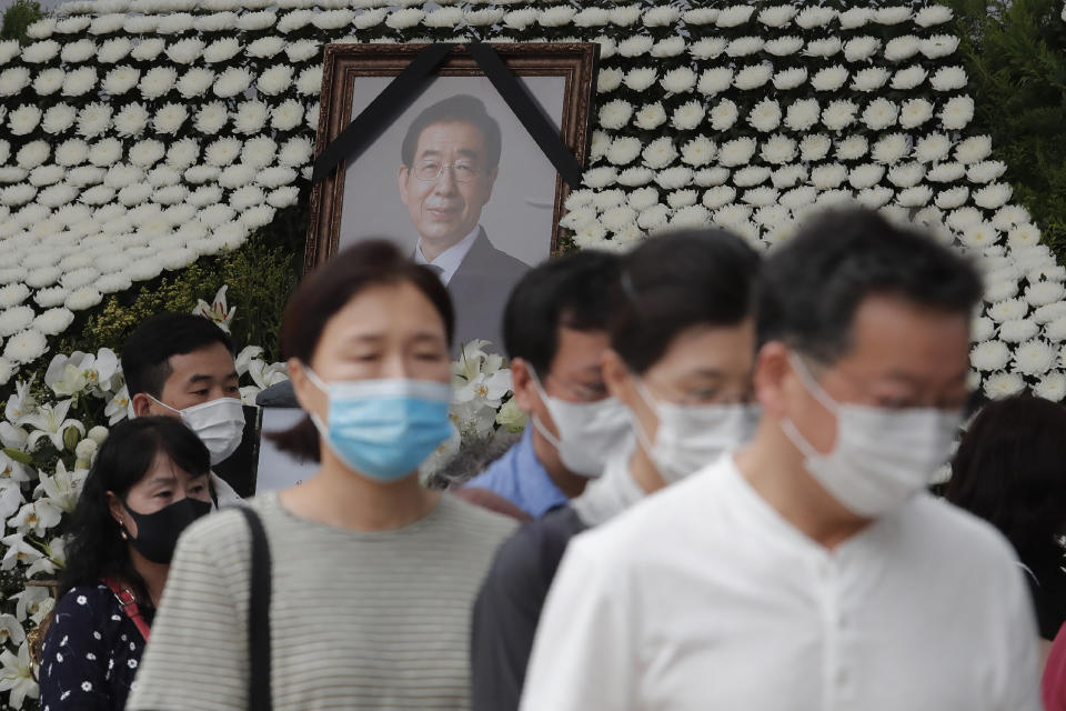 Mourners leave after paying their respects at a memorial for late Seoul Mayor Park Won-soon at the City Hall Plaza in Seoul, South Korea, Sunday, July 12, 2020. The sudden death of Seoul's mayor, reportedly implicated in a sexual harassment complaint, has prompted an outpouring of public sympathy even as it has raised questions about a man who built his career as a reform-minded politician and self-described feminist. (AP Photo/Ahn Young-joon)