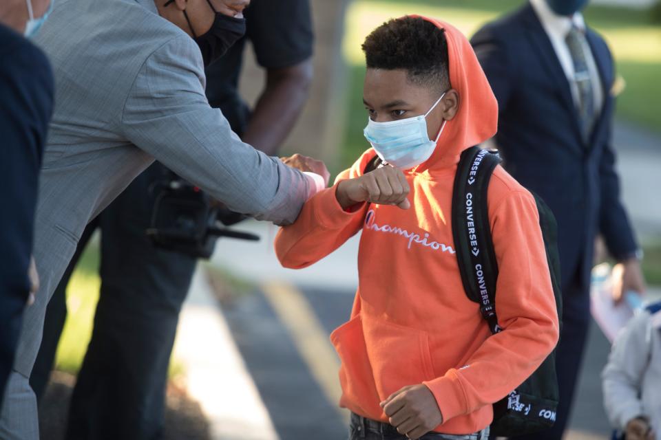 EastSide Charter School students trade elbows as they are welcomed back to school by elected officials and community members at the annual Suit Up Show Up Tuesday, Sept. 7, 2021, at EastSide Charter School in Wilmington. 