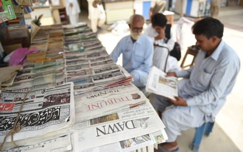 Pakistan's English-language Dawn newspaper is displayed for sale at a newspaper stall in Karachi on May 20  - Credit: AFP