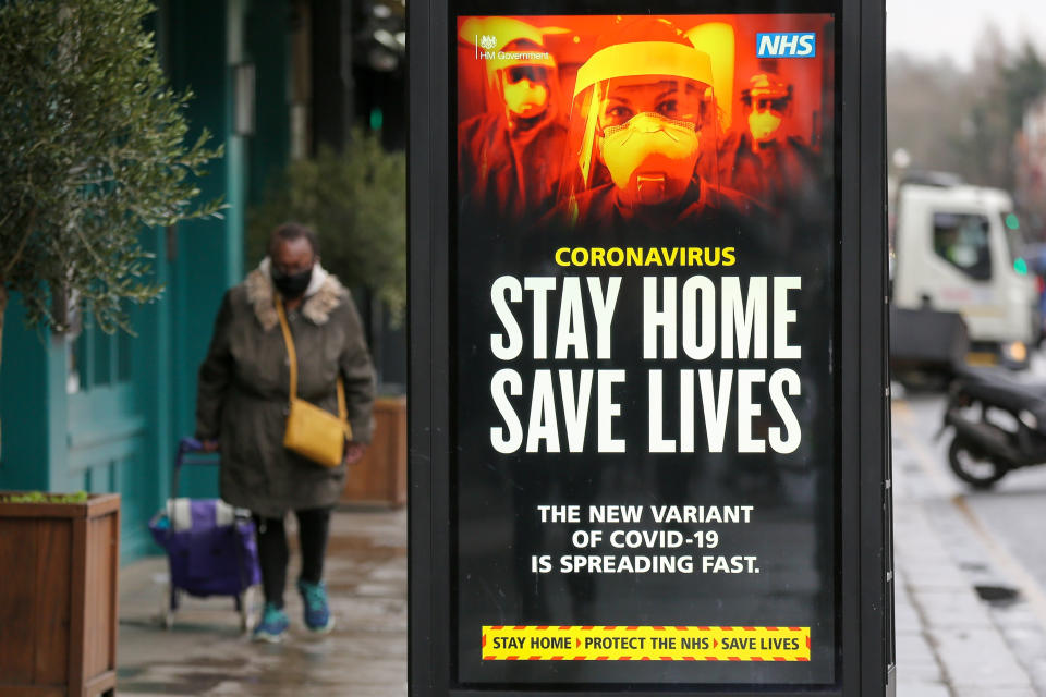 A woman walks past the Government's 'Stay Home, Save Lives' Covid-19 publicity campaign poster in London, as the number of cases of the mutated variant of the SARS-Cov-2 virus continues to spread around the country. (Photo by Dinendra Haria / SOPA Images/Sipa USA)