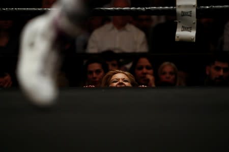 A woman reacts in support of Miriam Gutierrez "La Reina" as she fights Samantha Smith for the lightweight European Championship in Torrelodones