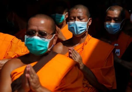 Buddhist monks chant at the gate of Dhammakaya temple in Pathum Thani province, Thailand February 19, 2017. REUTERS/Chaiwat Subprasom