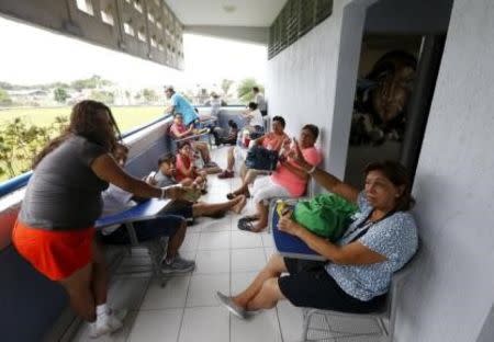 Residents, who were evacuated from their homes wait at the University of Puerto Vallarta used as a shelter as Hurricane Patricia approaches the Pacific beach resort of Puerto Vallarta, Mexico October 23. 2015. REUTERS/Henry Romero