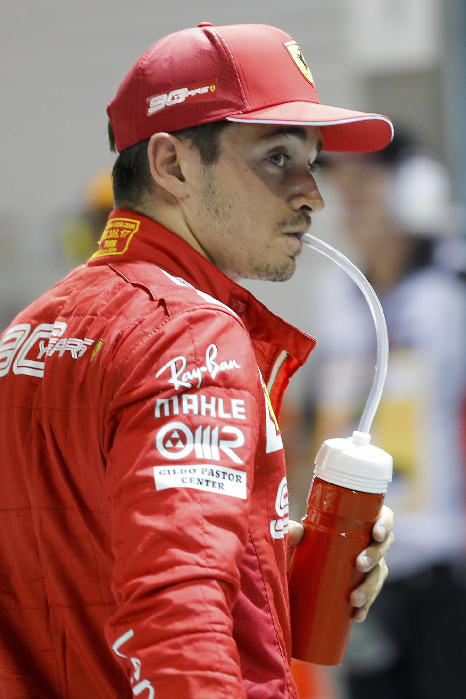 Ferrari driver Charles Leclerc of Monaco takes a drink after taking pole position in the qualifying session for the Singapore Formula One Grand Prix at the Marina Bay City Circuit in Singapore, Saturday, Sept. 21, 2019. (AP Photo/Vincent Thian)