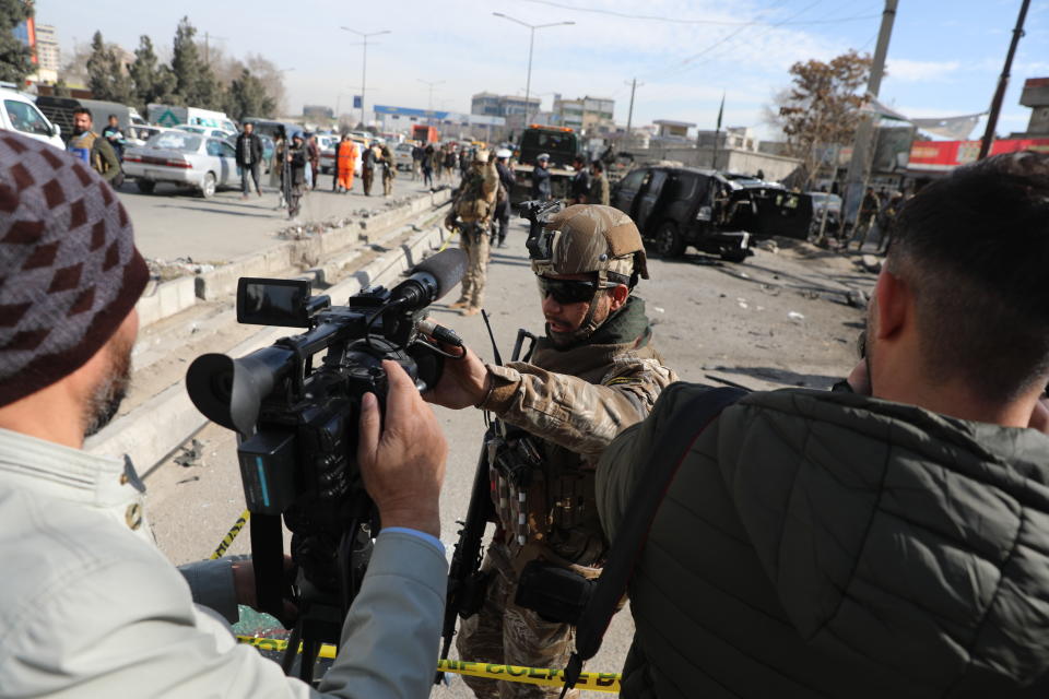 Afghan security police block a TV journalist from filming at the site of bombing attack in Kabul, Afghanistan, Feb. 10, 2021. The coordinated killings in Jalalabad on Tuesday, March 2, 2021, of three women working for a local radio and TV station in Jalalabad were the latest in a bloody campaign against journalists in Afghanistan, a country that was already considered one of the most dangerous places in the world to be a journalist. In just the last six months, 15 journalists have been killed in a series of targeted killings. (AP Photo/Rahmat Gul)