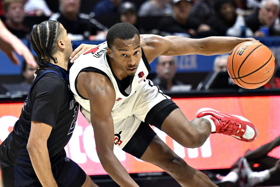 San Diego State guard Micah Parrish (3) drives against UC Irvine guard Justin Hohn during the second half of an NCAA college basketball game Saturday, Dec. 9, 2023, in San Diego. (AP Photo/Denis Poroy)
