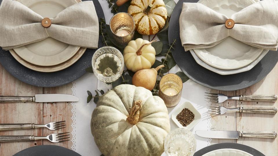 neutral tones place setting with whitewashed pumpkins, dried gourds and diy button napkin rings