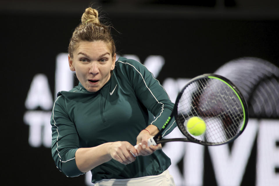 Romania's Simona Halep makes a backhand return to Australia's Ash Barty during an exhibition tennis event in Adelaide, Australia, Friday, Jan 29. 2021. (Kelly Barnes/AAP Image via AP)