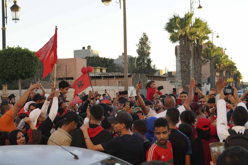 Moroccans celebrate their World Cup victory against Portugal in the Morocco-administered Western Sahara city of Laayoune, Saturday, Dec. 10, 2022. (AP Photo/Noureddine Abakchou)