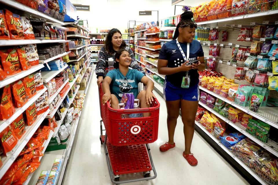 U.S. women's players Sulma Morales, Yuli Pineda and Sienna Jackson, shop at a Target store.