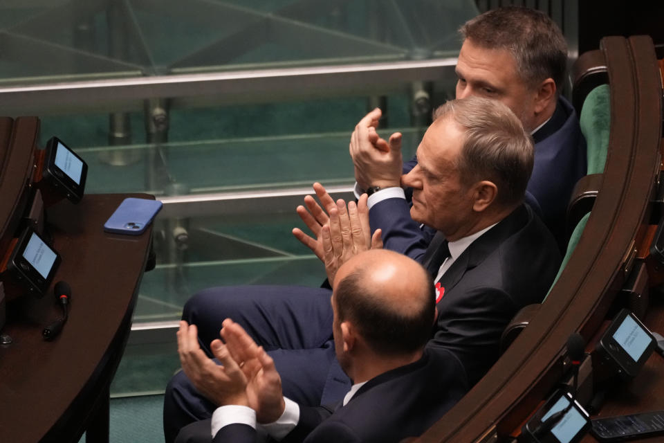 The leader of Poland's opposition alliance, Donald Tusk, centre, attends the first session of the lower house, or Sejm, of the newly-elected parliament in Warsaw, Poland, Monday Nov. 13, 2023. The Polish parliament gathered for the first time Monday after an election last month heralded a change of course for the Central European nation at a time of war across the border in Ukraine. (AP Photo/Czarek Sokolowski)