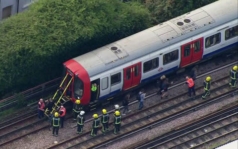 Passengers are led away from a District Line Tube at Parsons Green - Credit: AP