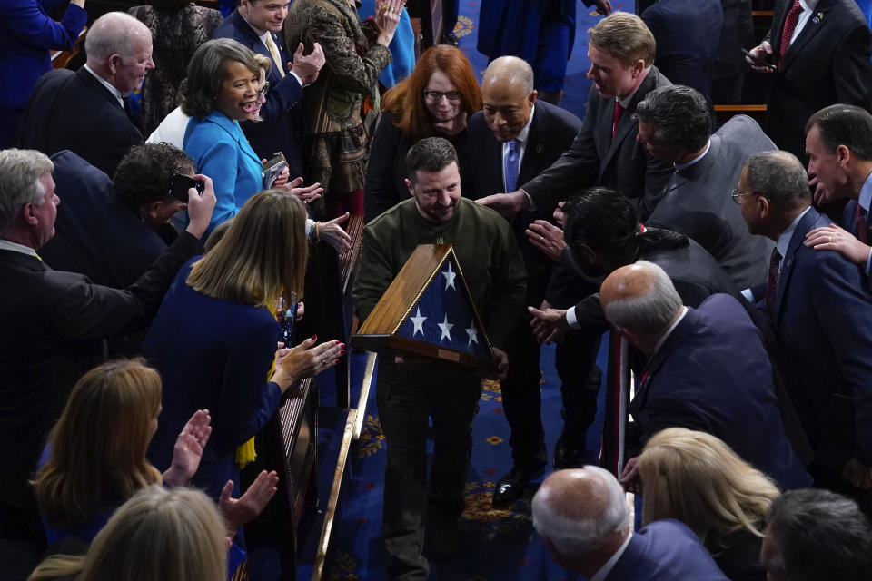 Ukrainian President Volodymyr Zelenskyy holds an American flag that was gifted to him by House Speaker Nancy Pelosi of Calif., as he leaves after addressing a joint meeting of Congress on Capitol Hill in Washington, Wednesday, Dec. 21, 2022. (AP Photo/Jacquelyn Martin)