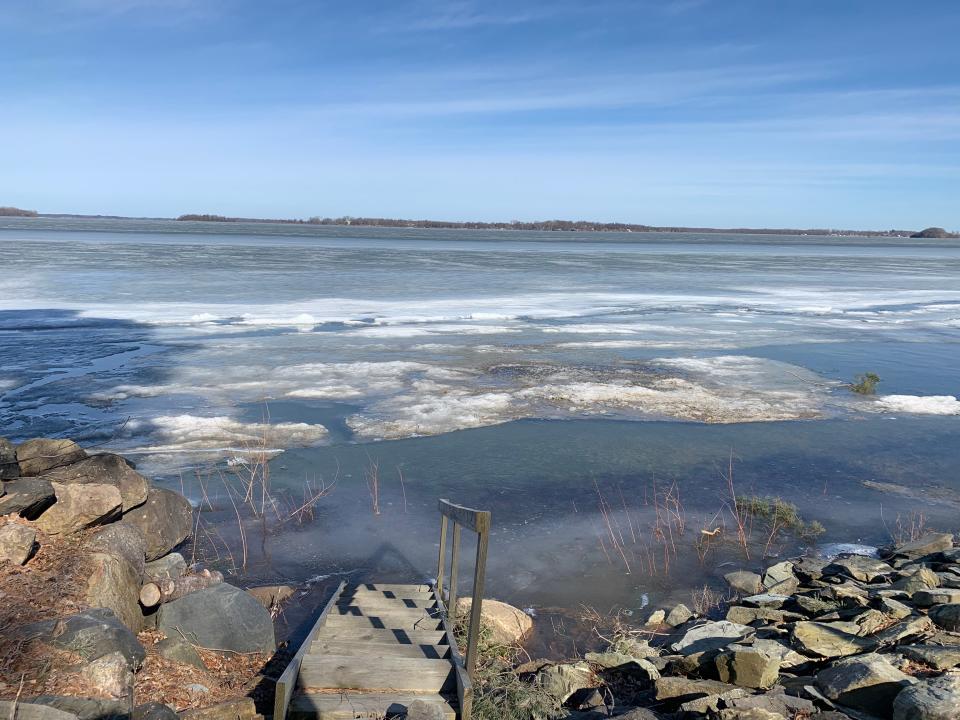 vermont lake during winter, water in the foreground and mountains in the background