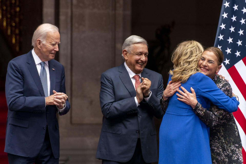 President Joe Biden and Mexican President Andres Manuel Lopez Obrador, watch as first lady Jill Biden and Obrador's wife Beatriz Gutiérrez Müller, right, hug during an arrival ceremony at the National Palace in Mexico City, Mexico, Monday, Jan. 9, 2023. (AP Photo/Andrew Harnik)