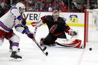 Carolina Hurricanes goaltender Antti Raanta (32) watches a shot by New York Rangers' Tyler Motte (64) pass by wide of the net during the first period of Game 2 of an NHL hockey Stanley Cup second-round playoff series in Raleigh, N.C., Friday, May 20, 2022. (AP Photo/Karl B DeBlaker)