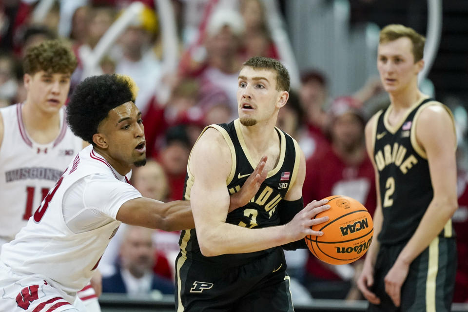 Wisconsin's Chucky Hepburn (23) reaches in on Purdue's Braden Smith (3) during the second half of an NCAA college basketball game Sunday, Feb. 4, 2024, in Madison, Wis. (AP Photo/Andy Manis)