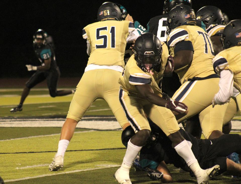 University Christian running back Orel Gray (4) tries to spin out of a Providence tackle  during a high school football game on Tuesday, September 27, 2022. [Clayton Freeman/Florida Times-Union]