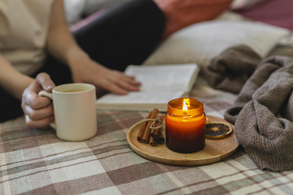 Girl sat studying with a candl. (Getty Images)