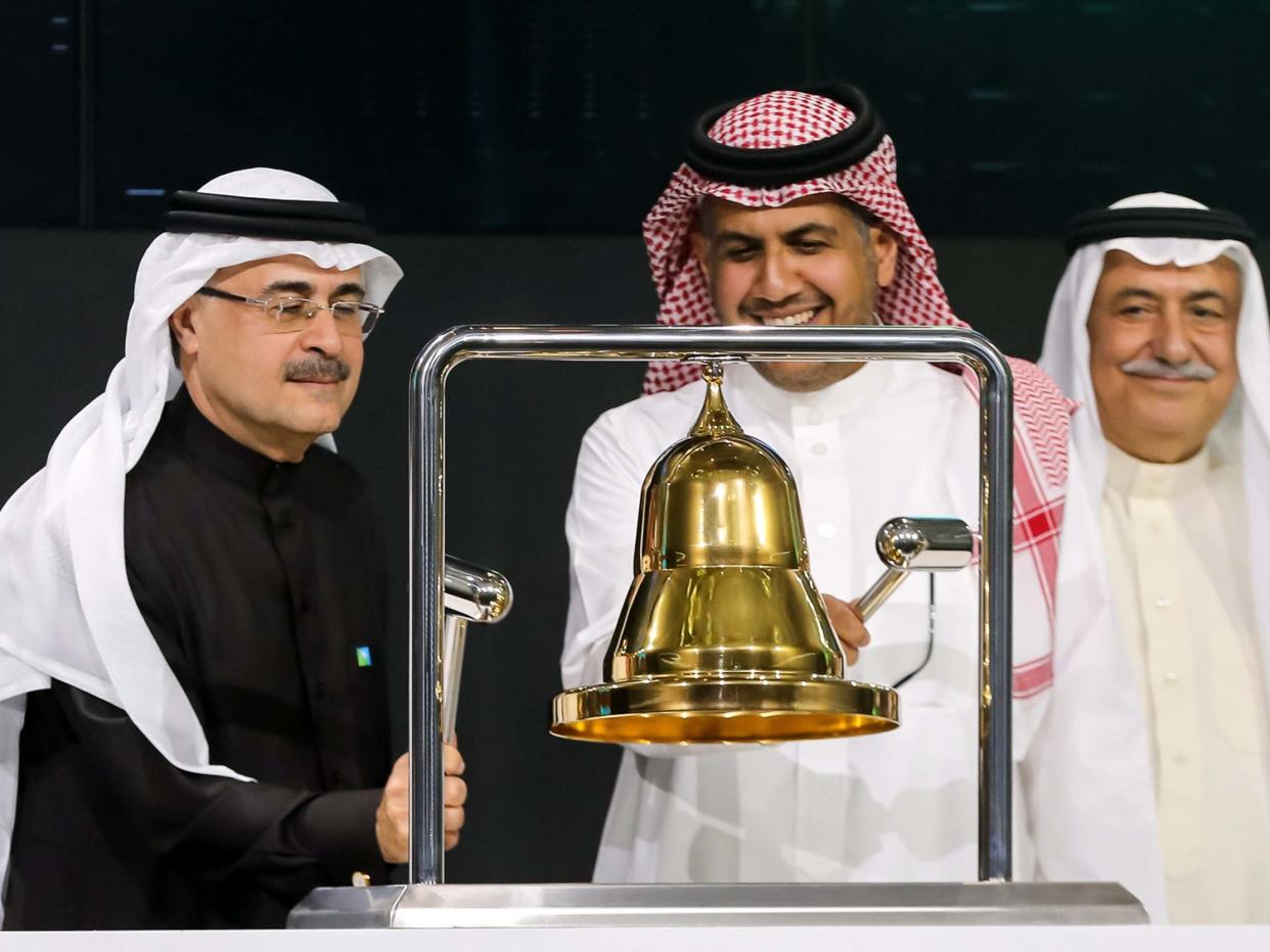 President and CEO of Saudi Aramco Amin Nasser (L) ringing the bell during a ceremony marking the debut of Saudi Aramco's initial public offering (IPO) on the Saudi Stock Exchange in Riyadh, Saudi Arabia: EPA