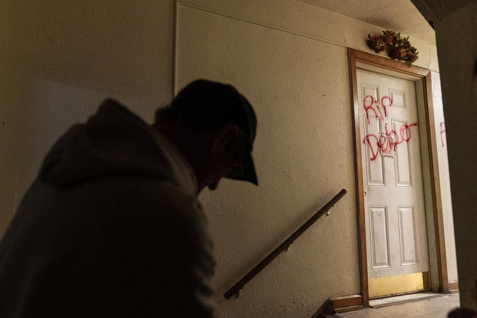 The message "RIP Debo" is spray painted on the apartment door that had been the home of 41-year-old Debbie Barnette, a mother of three, in Huntington, W.Va., Thursday, March 18, 2021. Barnette, bold and headstrong, had struggled with addiction all her life. She overdosed many times and developed the infections that often follow injection drug use. By the time she sought treatment, the infection in her heart was too far gone to save. Lying in a hospice bed, her sister, Lesa, had to tell her she was dying. Debbie asked her why. "The drugs got you, babe," Lesa remembers saying. "They got you." The only peace Lesa has is that now she's finally free. (AP Photo/David Goldman)