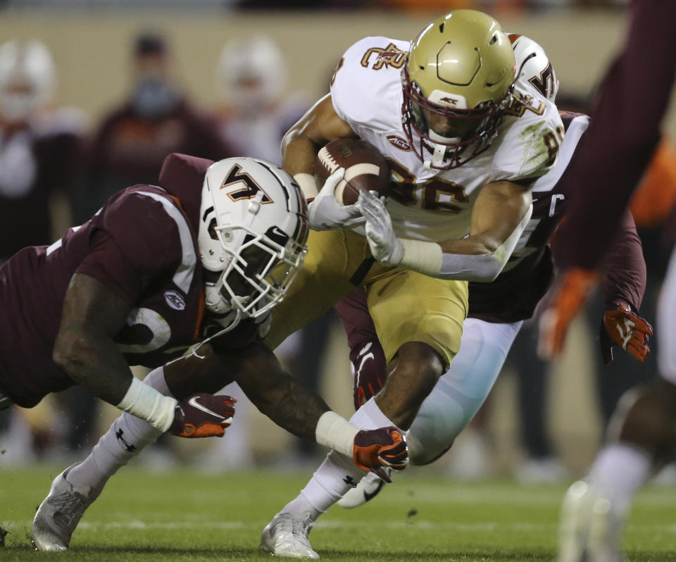 Jaelen Gill, right, of Boston College scores past Virginia Tech defenders Chamarri Conner, left, first half of an NCAA college football game in Blacksburg Va. Saturday, Oct. 17, 2020. (Matt Gentry/The Roanoke Times via AP, Pool)