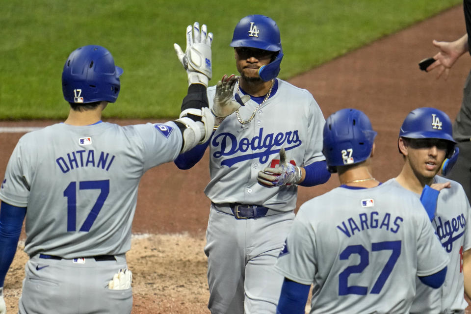 Los Angeles Dodgers' Mookie Betts is greeted by Shohei Ohtani (17) after hitting a three-run home run off Pittsburgh Pirates relief pitcher Ben Heller during the fifth inning of a baseball game in Pittsburgh, Thursday, June 6, 2024. (AP Photo/Gene J. Puskar)